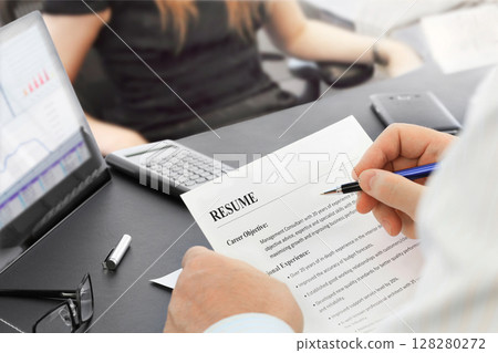 Job Interview in the office with focus on resume and pen Job Interview in the office with focus on resume and pen 128280272