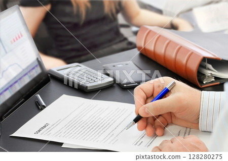 Male hand with pen signing a contract Male hand with pen signing a contract 128280275