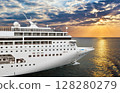 Luxury cruise ship sailing from port on sunset  128280279