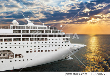 Luxury cruise ship sailing from port on sunset Luxury cruise ship sailing from port on sunset 128280279