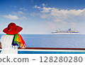 Lady on the ship looking at cruise ship sailing from port 128280280