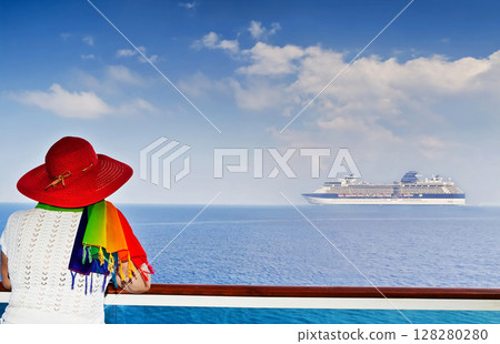 Lady on the ship looking at cruise ship sailing from port 128280280