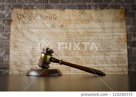 United States Constitution On Wall with Gavel Resting on Table in Front. United States Constitution On Wall with Gavel Resting on Table in Front. 128280335