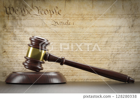 United States Constitution On Wall with Gavel Resting on Table in Front. United States Constitution On Wall with Gavel Resting on Table in Front. 128280338