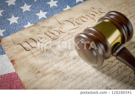 United States Constitution, Gavel and American Flag Resting on Table. 128280341