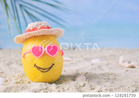 Creative minimal summer idea. Lemon citrus hipster in pink sunglasses and bamboo hat on sand. Tropical beach concept. Creative art. Fun party Mood. Copy space 128281750