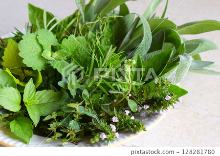 Fresh spicy and medicinal herbs on white background. Bouquet from various herb - rosemary, oregano, sage, marjoram, basil, thyme, mint. 128281780