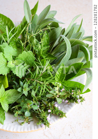 Fresh spicy and medicinal herbs on white background. Bouquet from various herb - rosemary, oregano, sage, marjoram, basil, thyme, mint. Fresh spicy and medicinal herbs on white background. Bouquet from various herb - rosemary, oregano, sage, marjoram, basil, thyme, mint. 128281782