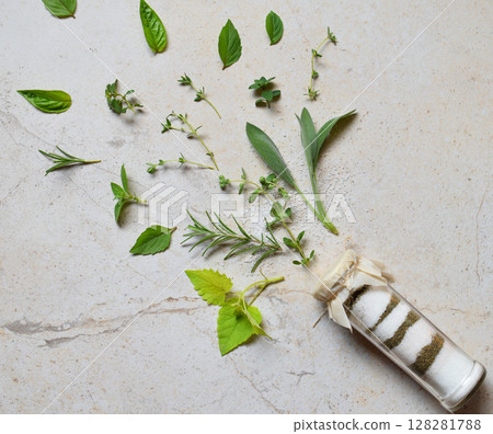 Ayurvedic herbal salt in glass jar. Sea salt with aromatic herb - rosemary, oregano, sage, marjoram, basil, thyme, mint, bay leaf. Copy space Ayurvedic herbal salt in glass jar. Sea salt with aromatic herb - rosemary, oregano, sage, marjoram, basil, thyme, mint, bay leaf. Copy space 128281788