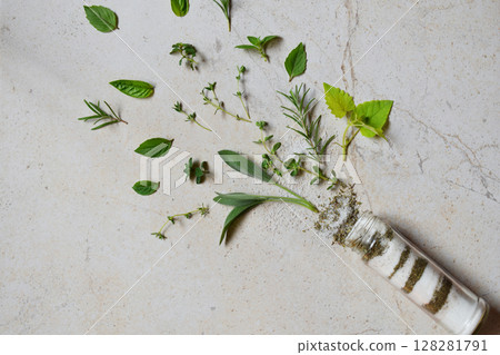 Ayurvedic herbal salt in glass jar. Sea salt with aromatic herb - rosemary, oregano, sage, marjoram, basil, thyme, mint, bay leaf. Copy space Ayurvedic herbal salt in glass jar. Sea salt with aromatic herb - rosemary, oregano, sage, marjoram, basil, thyme, mint, bay leaf. Copy space 128281791