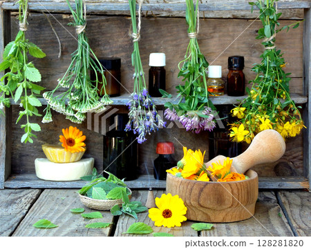 bunches of healing herbs - mint, yarrow, lavender, clover, hyssop, milfoil, mortar with flowers of calendula and bottles, herbal medicine bunches of healing herbs - mint, yarrow, lavender, clover, hyssop, milfoil, mortar with flowers of calendula and bottles, herbal medicine 128281820