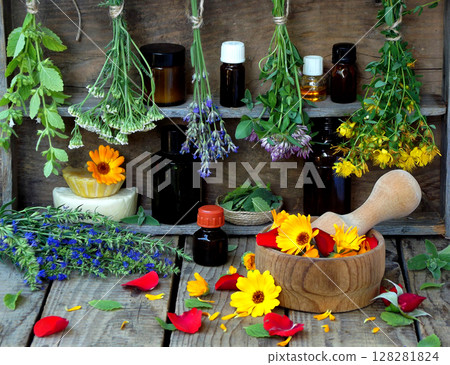 bunches of healing herbs - mint, yarrow, lavender, clover, hyssop, milfoil, mortar with flowers of calendula and bottles, herbal medicine bunches of healing herbs - mint, yarrow, lavender, clover, hyssop, milfoil, mortar with flowers of calendula and bottles, herbal medicine 128281824