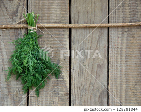 bunch of dill on wooden background. Copy space 128281844