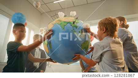 Science Lesson: Primary School Children Attaching Miniature Handmade Clouds to Earth Model Science Lesson: Primary School Children Attaching Miniature Handmade Clouds to Earth Model 128281867