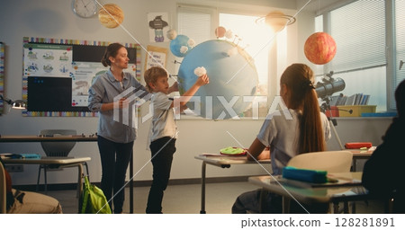 STEM Class: School Boy Presenting Renewable Energy Sources Using Model of Planet Earth STEM Class: School Boy Presenting Renewable Energy Sources Using Model of Planet Earth 128281891
