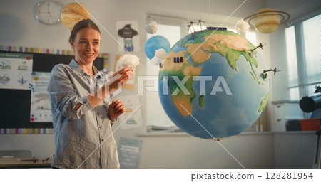 STEM Class: School Girl Presenting Renewable Energy Sources Using Model of Earth STEM Class: School Girl Presenting Renewable Energy Sources Using Model of Earth 128281954