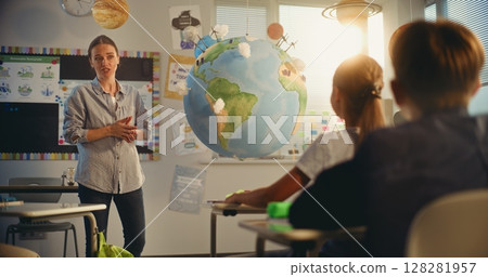 Primary School Girl Presenting Green Energy Sources in Front of Class Using Earth Model 128281957
