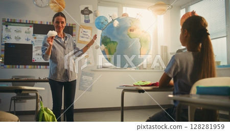 Primary School Boy Presenting Green Energy Sources in Front of Class Using Earth Model Primary School Boy Presenting Green Energy Sources in Front of Class Using Earth Model 128281959