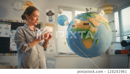 STEM Class: School Girl Presenting Renewable Energy Sources Using Model of Earth STEM Class: School Girl Presenting Renewable Energy Sources Using Model of Earth 128281961
