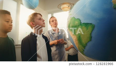 STEM Science Lesson: Primary School Children Studying Renewable Energy and Ecology Using Globe 128281966