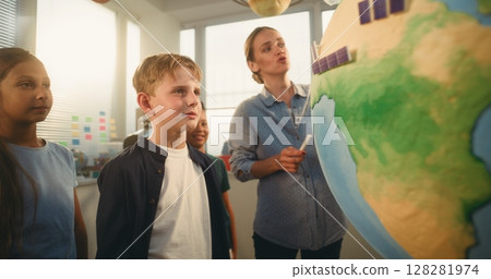 STEM Science Lesson: Primary School Children Studying Renewable Energy and Ecology Using Globe 128281974