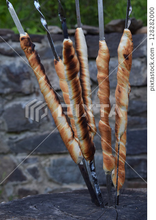 bread sticks of dough cooked on a fire. Italian breadsticks from wholemeal flour with herbs 128282000