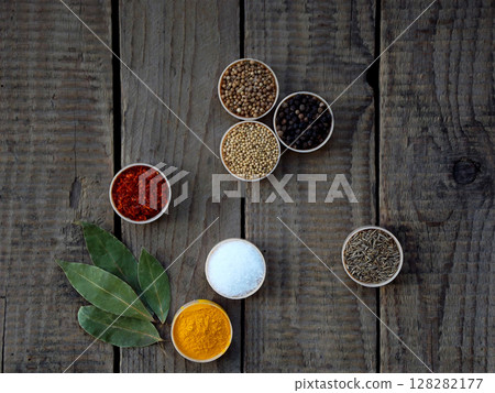 spices on a wooden background. Coriander, black pepper, paprika, mustard, turmeric, cumin. Mix for barbecue. spices on a wooden background. Coriander, black pepper, paprika, mustard, turmeric, cumin. Mix for barbecue. 128282177