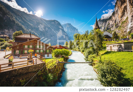 Majestic view of alpine village. Swiss alps, Lauterbrunnen valley, Staubbach waterfall, Europe. 128282497