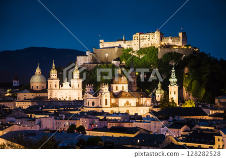 Great  view from the top on an evening city shining in the lights. Location famous place (unesco heritage) Festung Hohensalzburg, Salzburger Land, Austria, Europe. Beauty world. 128282528