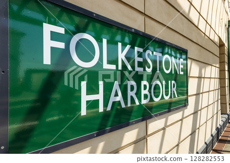 Close up of vintage green enamel Folkestone Harbour railway station sign 128282553