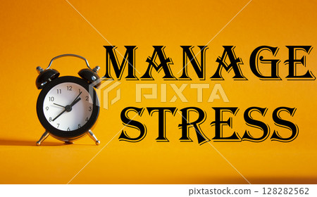 Manage stress symbol. Concept word Manage stress on Beautiful orange background with alarm clock. Medicine and Manage stress concept. Copy space 128282562