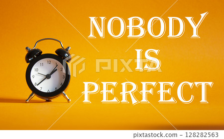 Nobody is Perfect symbol. Concept word Nobody is Perfect on Beautiful orange background with alarm clock. Business and Nobody is Perfect concept. Copy space Nobody is Perfect symbol. Concept word Nobody is Perfect on Beautiful orange background with alarm clock. Business and Nobody is Perfect concept. Copy space 128282563