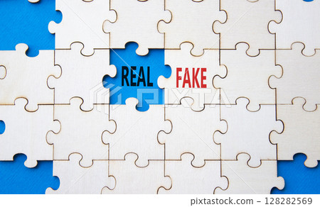 Real or Fake symbol. Concept word Real or Fake on wooden blocks. Beautiful blue background. Business and Real or Fake concept. Copy space 128282569