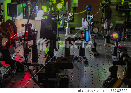 Experiment with laser device in optical laboratory.  128282591