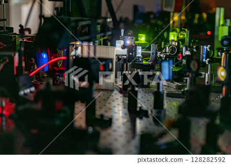 Experiment with laser device in optical laboratory.  128282592