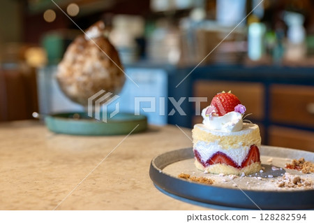 Cute strawberry cake and shaved ice in the background 128282594