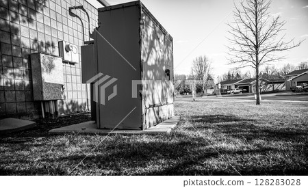 Rusted and peeling paint on an electrical transformer exposed to the elements.  128283028