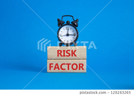 Risk Factor symbol. Wooden blocks with words Risk Factor Beautiful blue background with alarm clock. Business and Risk Factor concept. Copy space. Risk Factor symbol. Wooden blocks with words Risk Factor Beautiful blue background with alarm clock. Business and Risk Factor concept. Copy space. 128283265