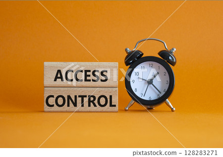 Access Control symbol. Concept words Access Control on wooden blocks. Beautiful orange background with alarm clock. Business and Access Control concept. Copy space. 128283271