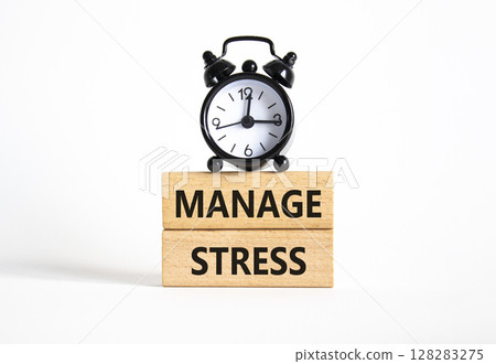 Manage stress symbol. Concept word Manage stress on wooden blocks. Beautiful white background with alarm clock. Business and Manage stress concept. Copy space Manage stress symbol. Concept word Manage stress on wooden blocks. Beautiful white background with alarm clock. Business and Manage stress concept. Copy space 128283275