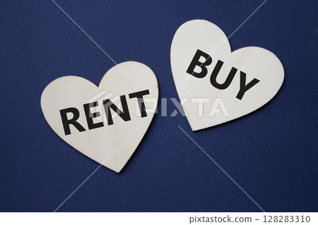 Rent or Buy symbol. Concept word Rent or Buy on wooden hearts. Beautiful deep blue background. Business and Rent or Buy concept. Copy space 128283310