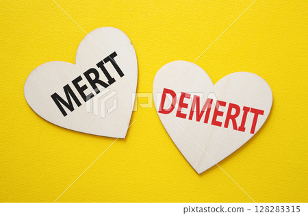 Merit or Demerit symbol. Concept word Merit or Demerit on wooden hearts. Beautiful yellow background. Business and Merit or Demerit concept. Copy space 128283315
