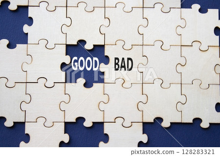 Good or Bad symbol. Concept word Good or Bad on wooden puzzle. Beautiful deep blue background. Business and Good or Bad concept. Copy space Good or Bad symbol. Concept word Good or Bad on wooden puzzle. Beautiful deep blue background. Business and Good or Bad concept. Copy space 128283321