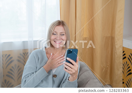 Senior woman talking via mobile phone 128283363