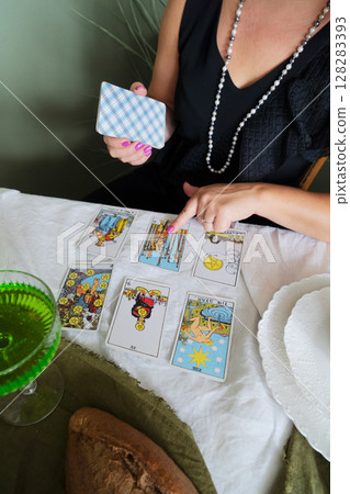 Tarot Reading Session with Vintage Cards and Elegant Decor 128283393