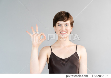 Happy young girl isolated over gray background Happy young girl isolated over gray background 128283396