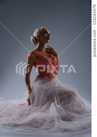 Bride in a vintage gown poses dramatically with blood accents in a studio Bride in a vintage gown poses dramatically with blood accents in a studio 128283478