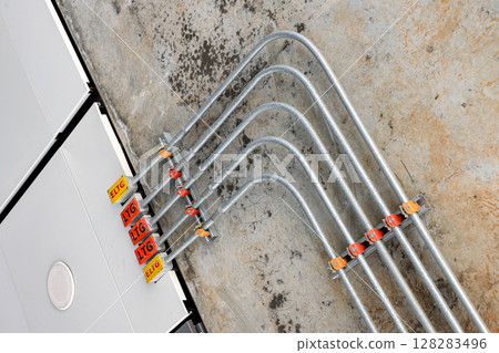 Steel Tube Fitting, Electricity and signal wire tubes attached on wall and ceiling, loft design or concept. Tube for LTG, ELTG cable. Steel Tube Fitting, Electricity and signal wire tubes attached on wall and ceiling, loft design or concept. Tube for LTG, ELTG cable. 128283496