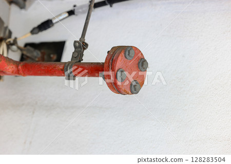 Close up old steel metal pipe of Fire extinguishing system attached to the wall in Construction. 128283504