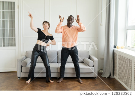 Couple of young man and woman dancing at home 128283562